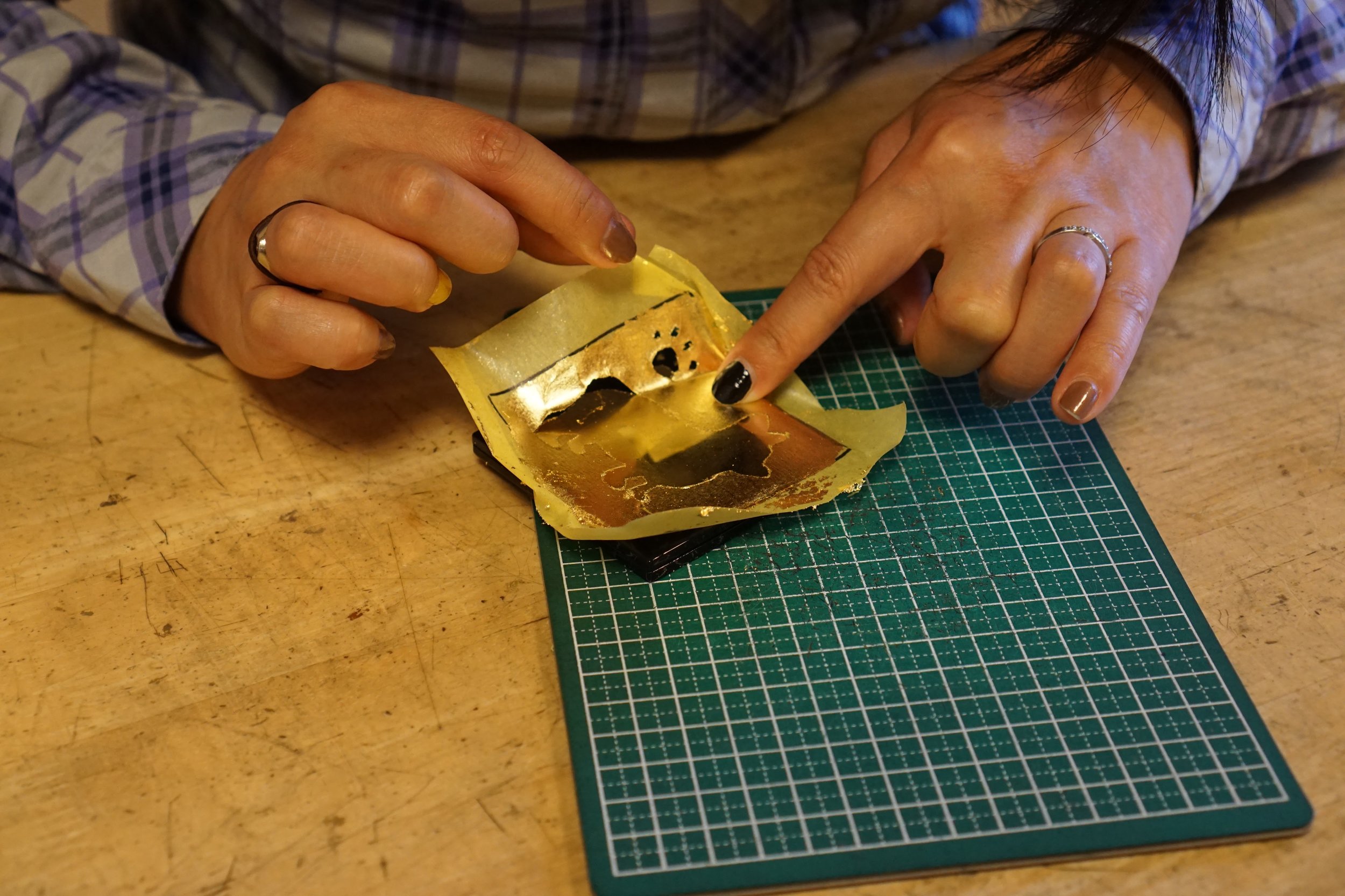 Applying the gold leaf