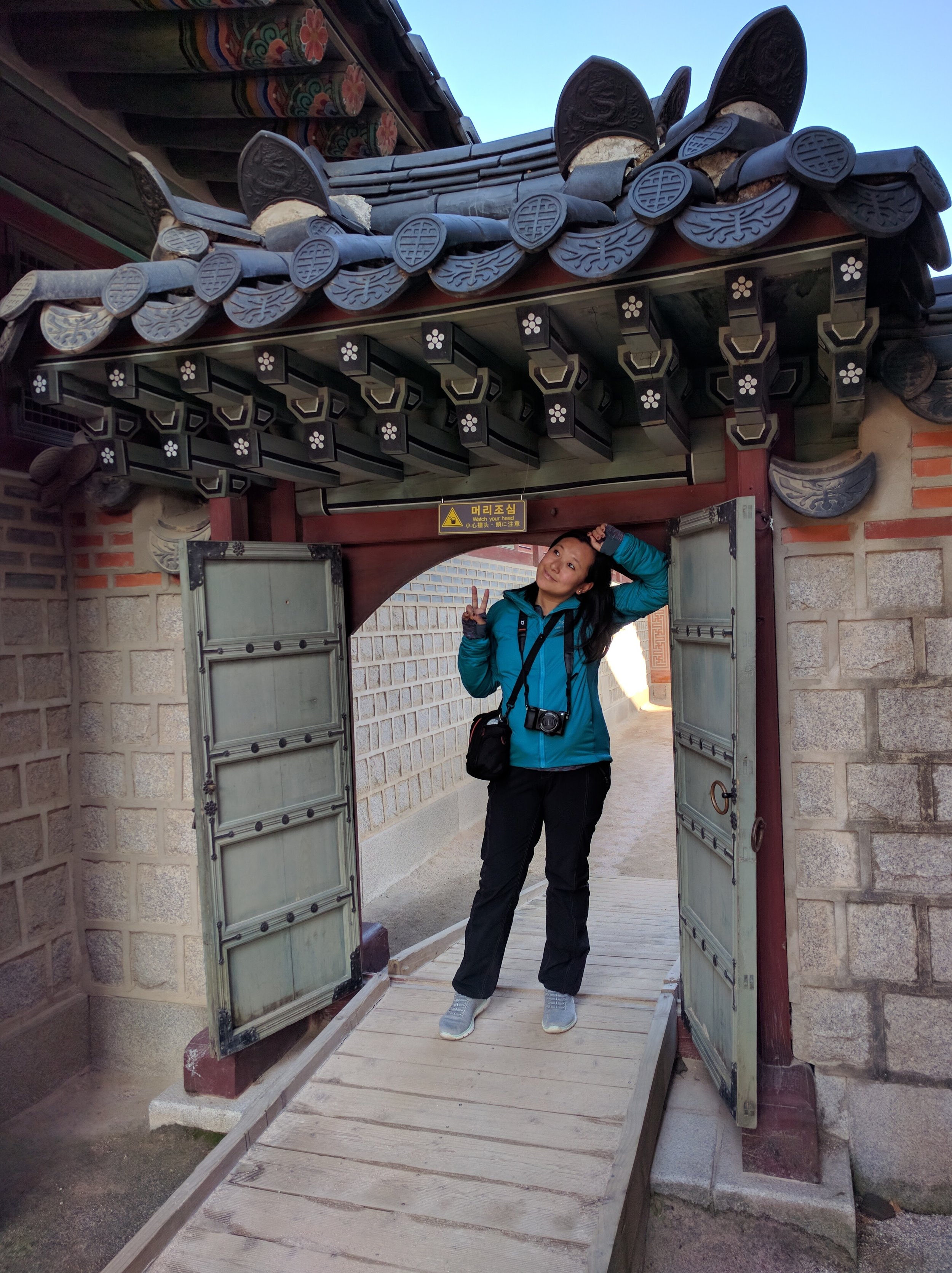 Mocking the poses of Asians in the doorways