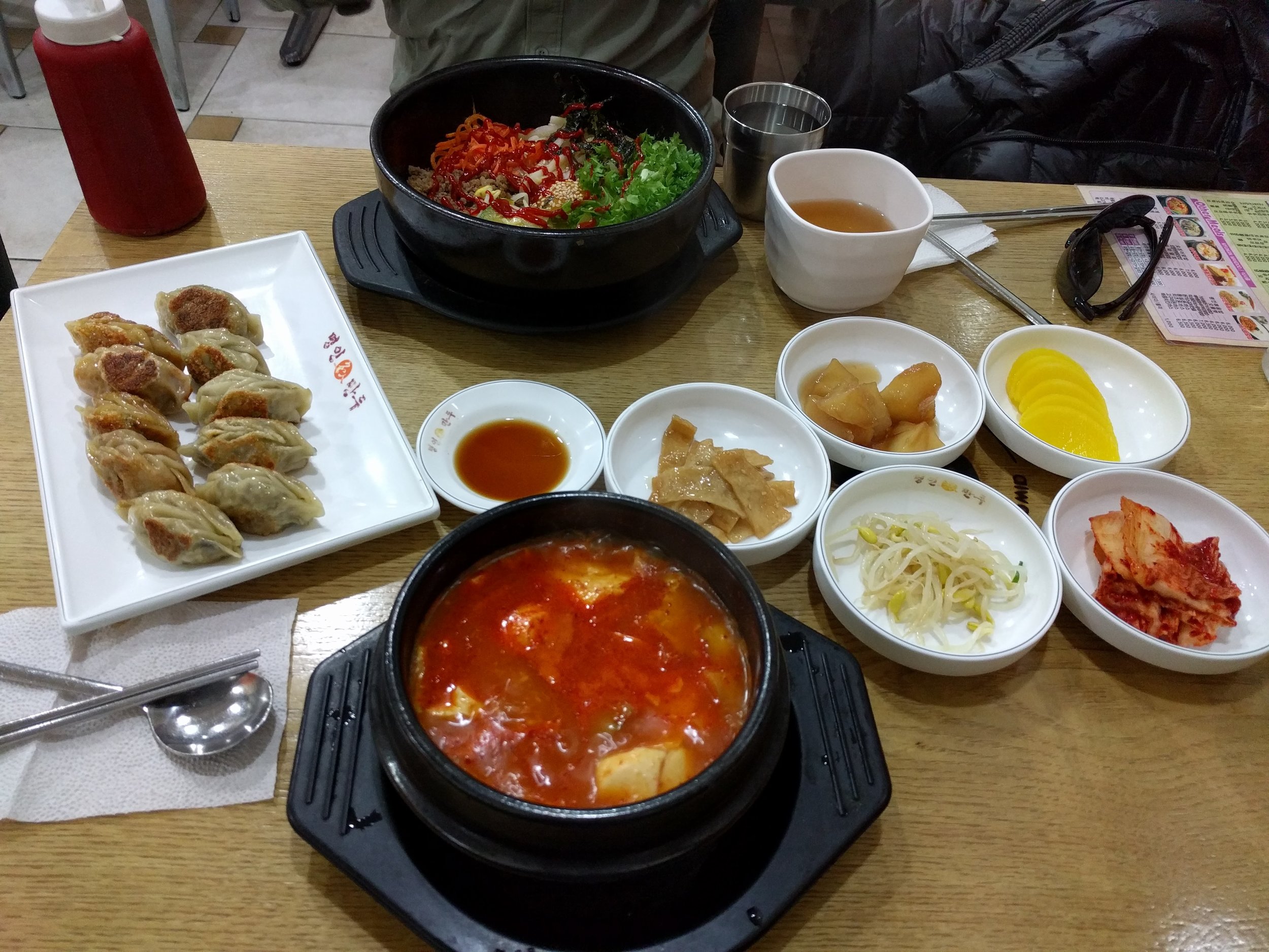 <p>We didn't realize that bibimbap isn't automatically in the hot stone pot until we got to Korea, but now we know! We also got a side of fried mandu, these were smaller than the others and tasted more like gyoza</p>