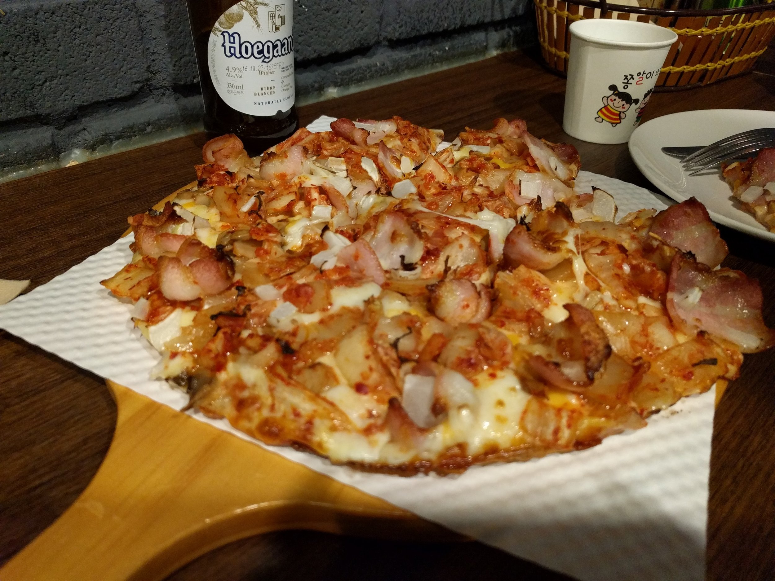 <p>A snack that ended up being more food than intended in Haebangchon, a artsier cuter version of Itaewon imho. This pizza is from Bonny's which is a NZ owner apparently? Kimchi + bacon + cheese does not sound like a winning combination but it was really good</p>