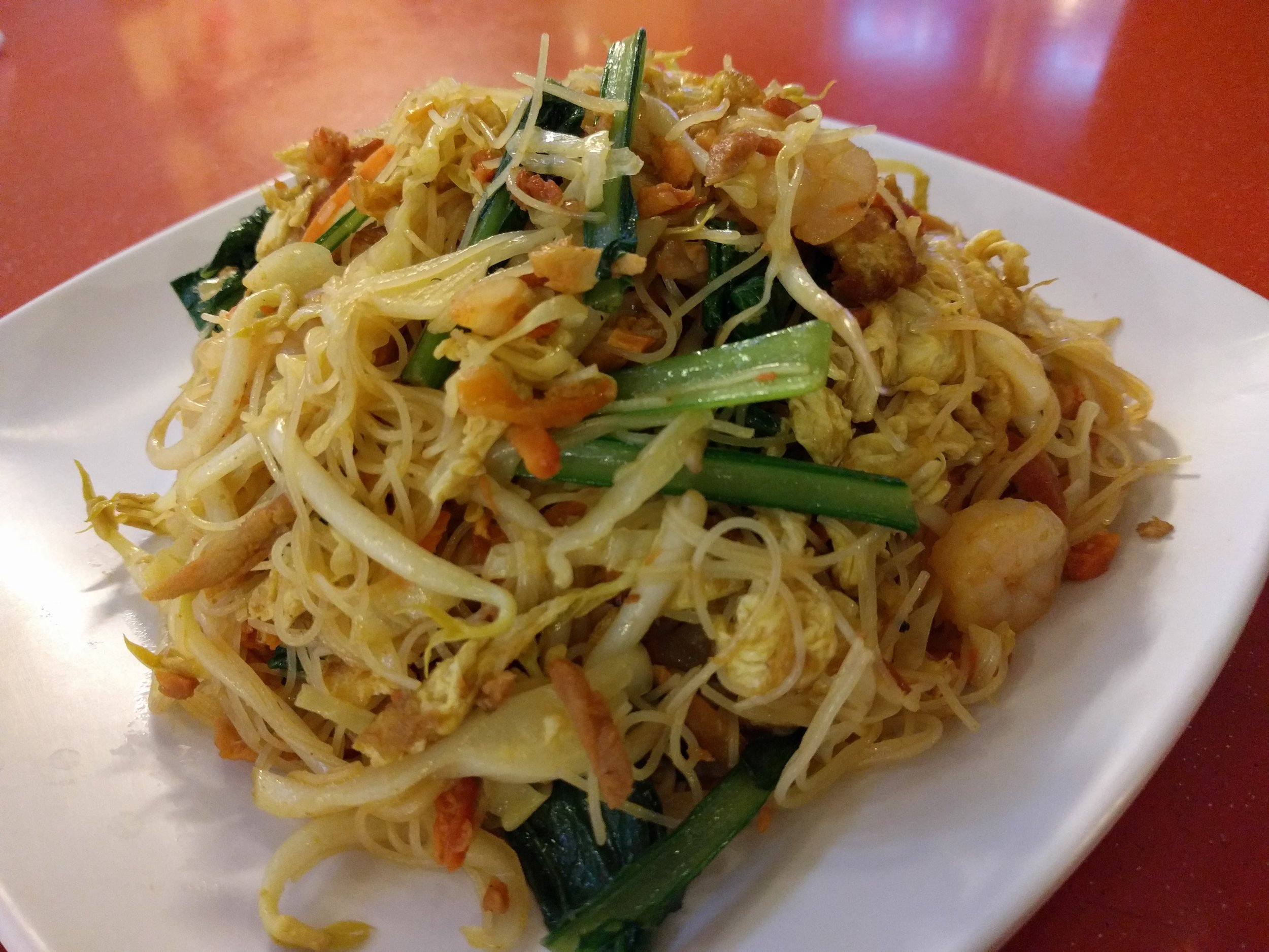 <p>Not as curry flavored as "Singapore noodles" you get in the states.</p>