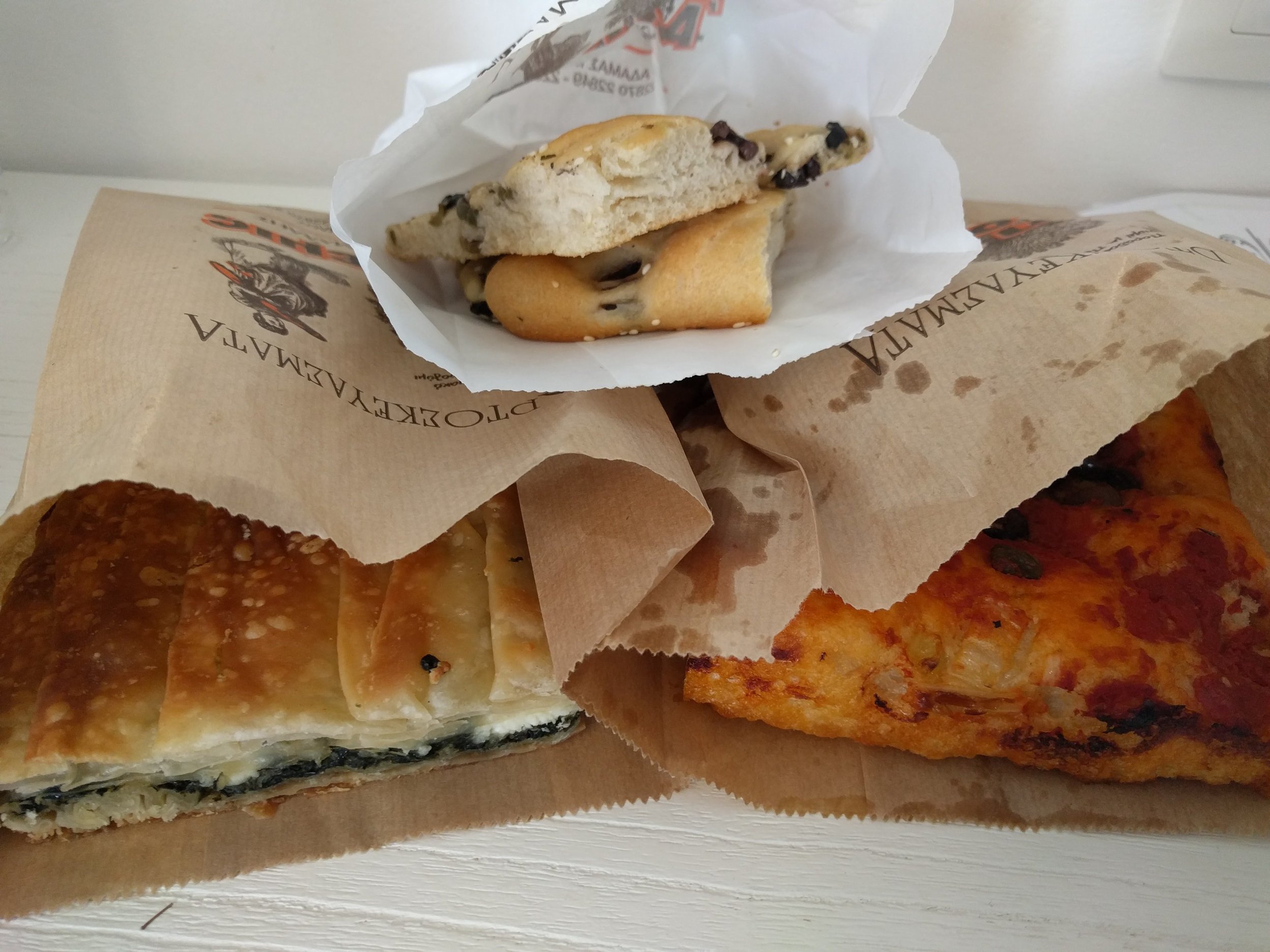 <p>Got an assortment of spanakopia,&nbsp;ladenya (sp?) and olive bread for breakfast/lunch. The ladenya is a traditional Milos bread with tomatoes, onions and olives that was similar to a pizza, but is most definitely not pizza as the shopkeeper told us</p>