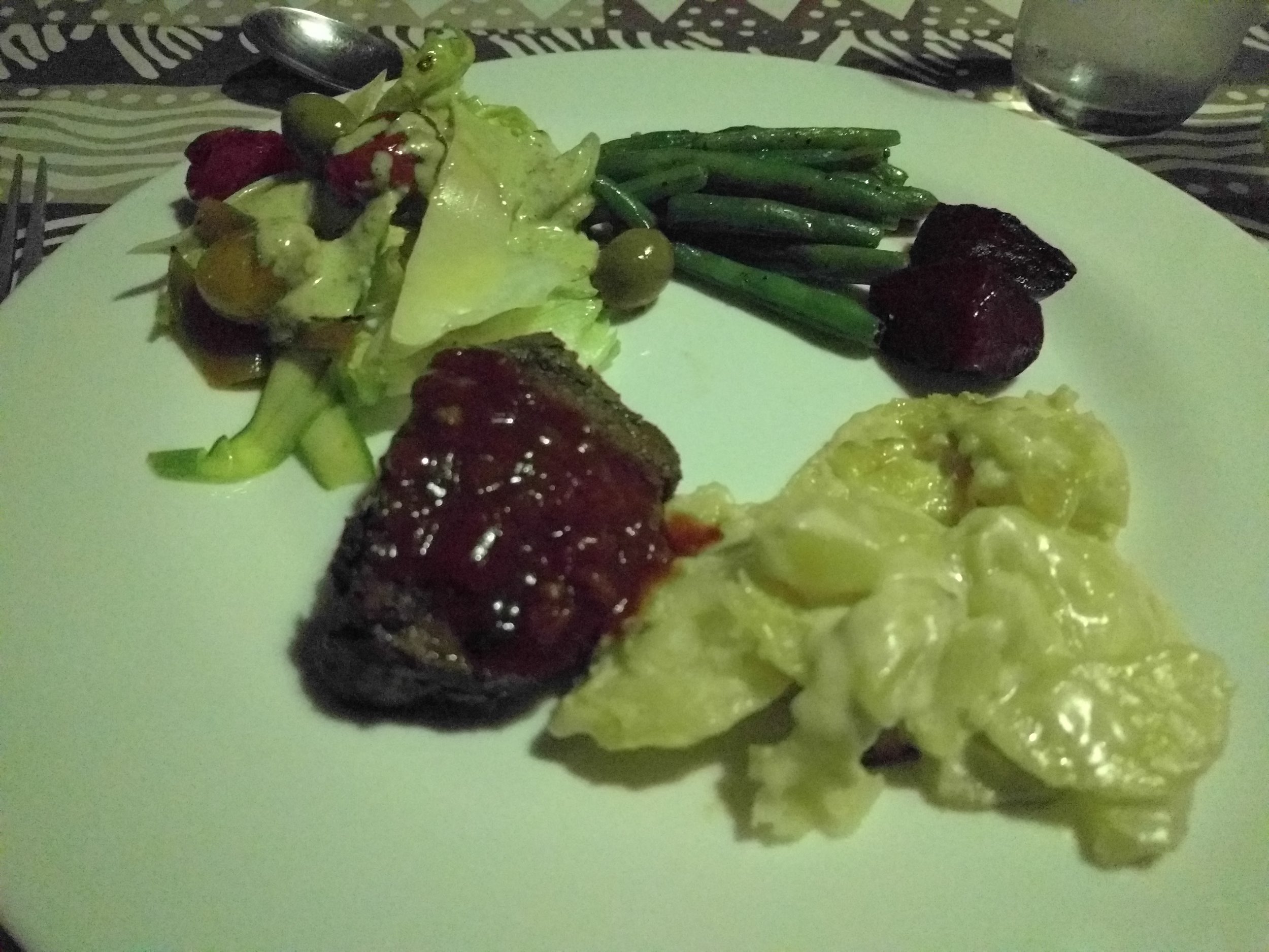 Beef filet, potatoes dauphin, greek salad, green beans, roasted veggies
