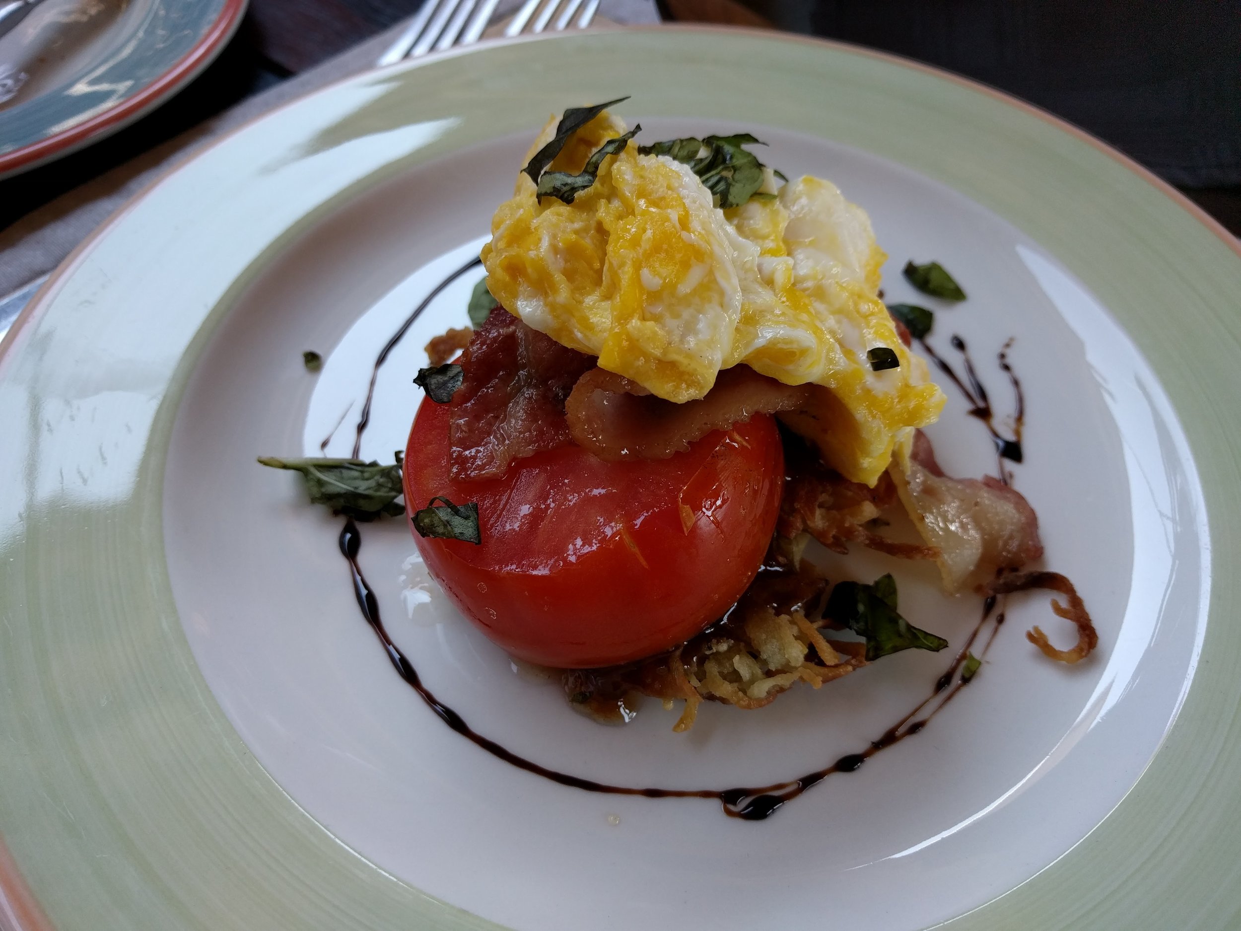 Hot breakfast - sweet potato fritter with tomato egg and bacon